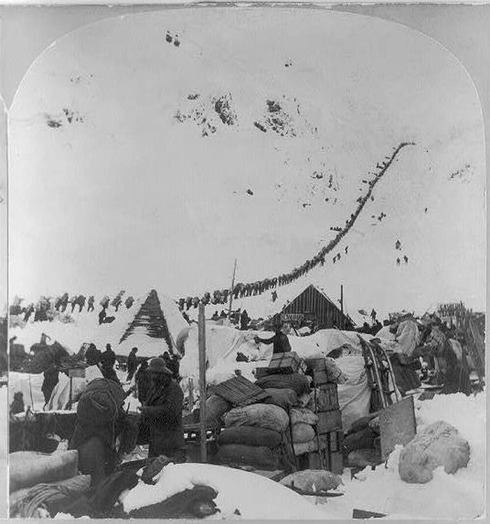 A long line of 19th-century prospectors make their way to Canada's Klondike gold fields through the Chilkoot   Pass in Alaska.