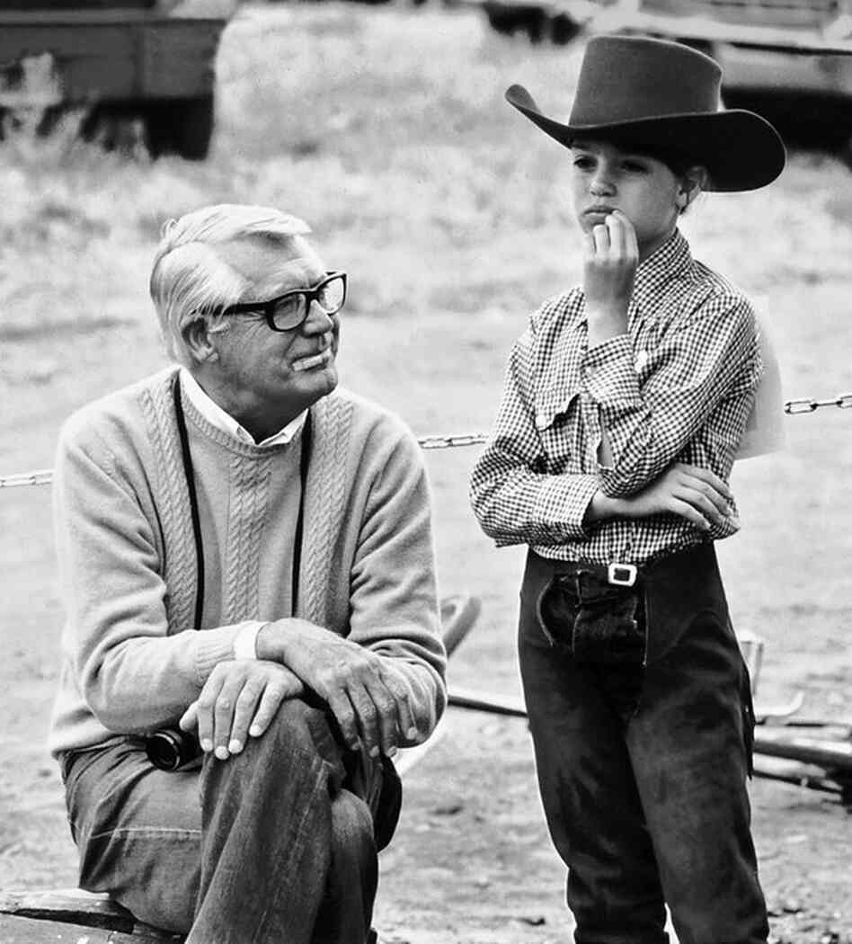 Cary Grant wears one of his signature camel-colored cashmere sweaters to Jennifer's horse show in Malibu, Calif. 