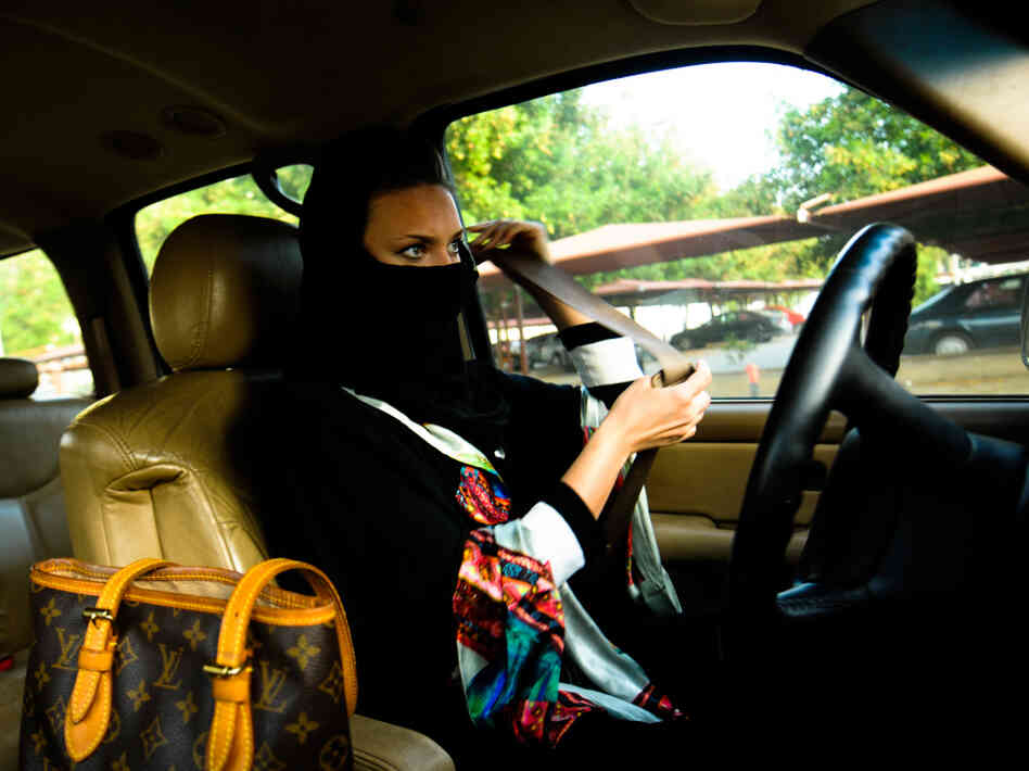 A Saudi woman fastens her seat belt before driving in Jeddah, western Saudi Arabia.