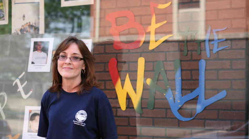 Portsmouth Public Health Nurse Lisa Roberts helped found the Scioto County Prescription Drug Action Team. Behind her is a memorial to victims of prescription drug abuse.