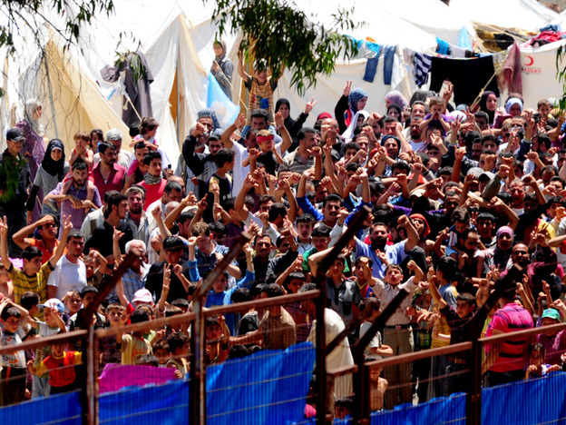 Syrian refugees gather for a protest against Syrian President Bashar al-Assad at the Turkish Red Crescent camp in the Yayladagi district of the Turkish city of Hatay, near the Syrian border, on June 20.