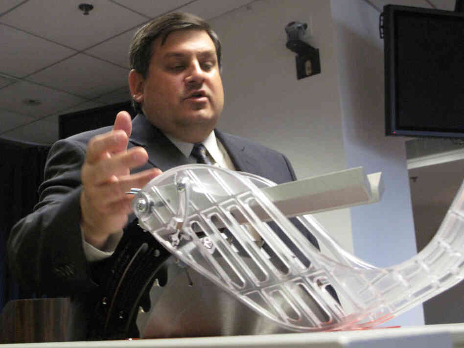 Thomas Siwek, director of product safety at Robert Bosch Tool Corp., demonstrates a newly designed guard for table saws at a meeting with the Consumer Product Safety Commission. Industry officials say the new guards make the saws safe. But consumer advocates disagree and are pushing for flesh-sensing technology such as SawStop, which they say will virtually eliminate the worst table saw injuries. Thomas Siwek, director of product safety at Robert Bosch Tool Corp., demonstrates a newly designed guard for table saws at a meeting with the Consumer Product Safety Commission. Industry officials say the new guards make the saws safe. But consumer advocates disagree and are pushing for flesh-sensing technology such as SawStop, which they say will virtually eliminate the worst table saw injuries.