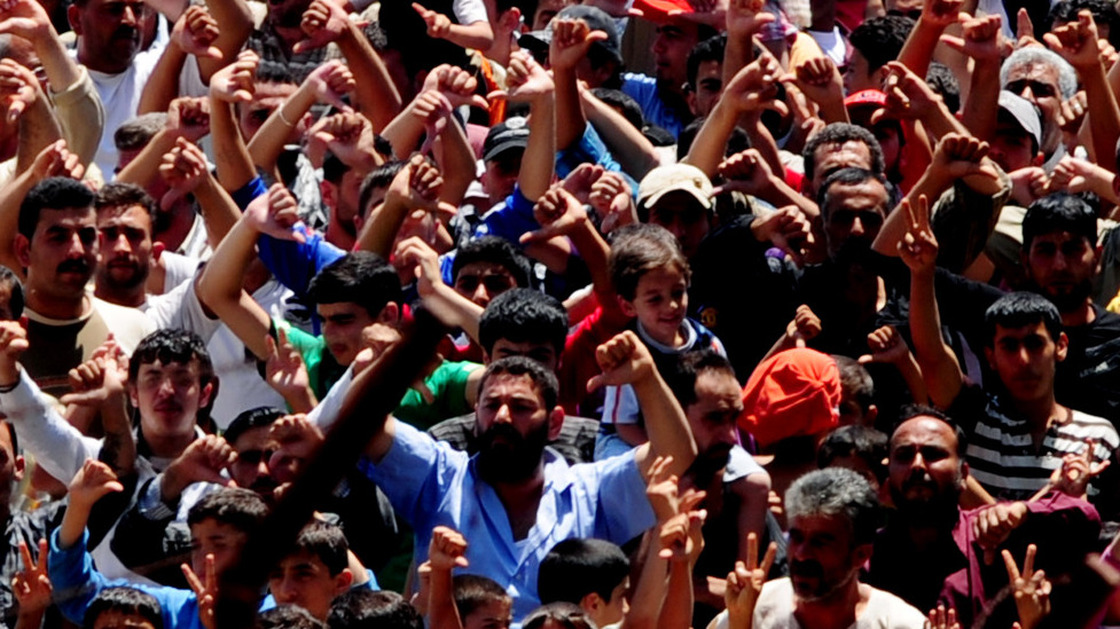 Syrian refugees gather for a protest against Syrian President Bashar al-Assad at the Turkish Red Crescent camp in the Yayladagi district of the Turkish city of Hatay, two kilometers from the Syrian border, on June 20, 2011.