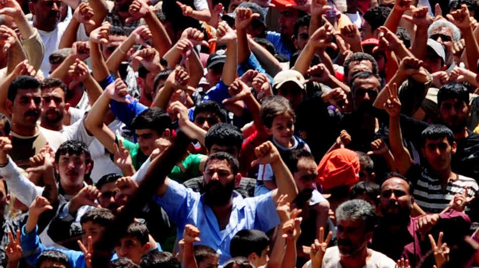 Syrian refugees gather for a protest against Syrian President Bashar al-Assad at the Turkish Red Crescent camp in the Yayladagi district of the Turkish city of Hatay, two kilometers from the Syrian border, on June 20, 2011.