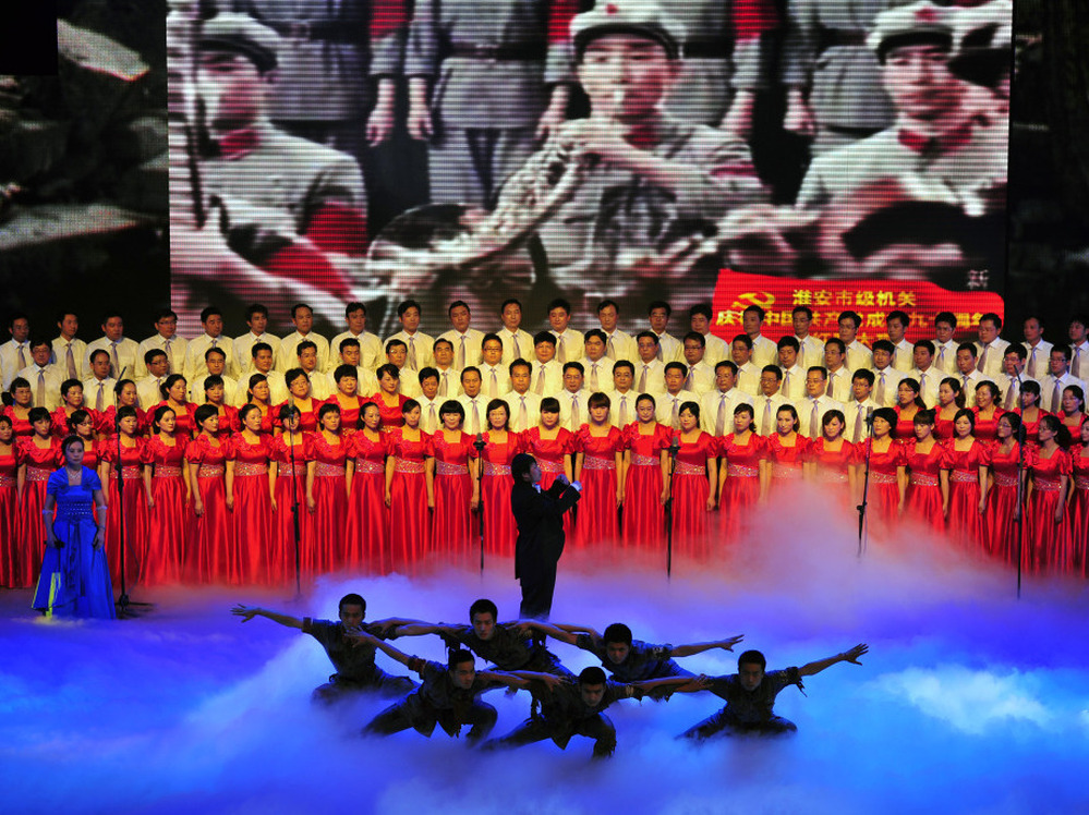 Officers from Huaian city perform patriotic "red songs" at the Huaian Great Hall of the People to mark the 90th anniversary of the founding of the Communist Party of China.