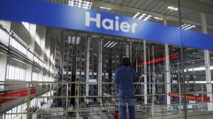 A worker stands in a warehouse at China's Qingdao Haier refrigerator factory. Despite being the world's largest maker of refrigerators, Haier is not widely known as a Chinese company.