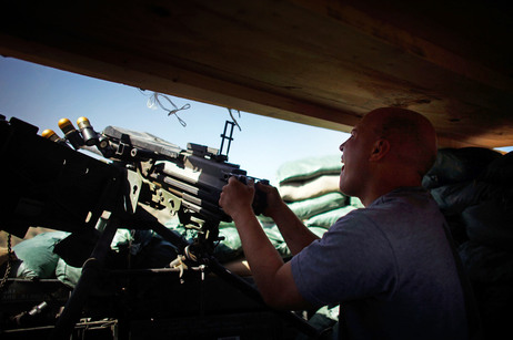 Specialist Gregory Goodrich, from Paw Paw Michigan, with Butcher Troop, part of the US Army 1st Infantry Division, fires a Mark 19 grenade launcher at a Taliban mortar team as incoming rounds were hitting just outside the bunker at Combat Outpost Wilderness in Paktia provence, eastern Afghanistan. Specialist Gregory Goodrich, from Paw Paw Michigan, with Butcher Troop, part of the US Army 1st Infantry Division, fires a Mark 19 grenade launcher at a Taliban mortar team as incoming rounds were hitting just outside the bunker at Combat Outpost Wilderness in Paktia provence, eastern Afghanistan.