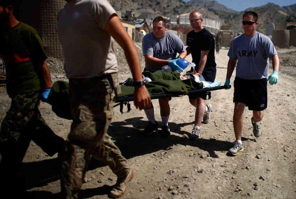 Medics with Butcher Troop, part of the US Army's 1st Infantry Division, rush a critically wounded Afghan National Army soldier to a waiting medevac helicopter after he was struck in the head with shrapnel from a mortar fired insurgents at Combat Outpost Wilderness in Paktia provence.At least 12 mortar rounds were fired at the base by Taliban insurgents from a nearby mountain top across the valley. Medics with Butcher Troop, part of the US Army's 1st Infantry Division, rush a critically wounded Afghan National Army soldier to a waiting medevac helicopter after he was struck in the head with shrapnel from a mortar fired insurgents at Combat Outpost Wilderness in Paktia provence.At least 12 mortar rounds were fired at the base by Taliban insurgents from a nearby mountain top across the valley.