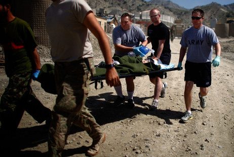 Medics with Butcher Troop, part of the US Army's 1st Infantry Division, rush a critically wounded Afghan National Army soldier to a waiting medevac helicopter after he was struck in the head with shrapnel from a mortar fired insurgents at Combat Outpost Wilderness in Paktia provence.At least 12 mortar rounds were fired at the base by Taliban insurgents from a nearby mountain top across the valley. Medics with Butcher Troop, part of the US Army's 1st Infantry Division, rush a critically wounded Afghan National Army soldier to a waiting medevac helicopter after he was struck in the head with shrapnel from a mortar fired insurgents at Combat Outpost Wilderness in Paktia provence.At least 12 mortar rounds were fired at the base by Taliban insurgents from a nearby mountain top across the valley.