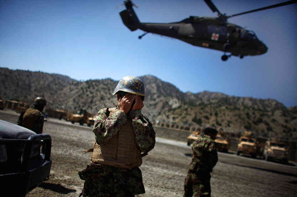 A US Army medevac Blackhawk helicopter lifts off carrying a critically injured Afghan National Army soldier as his fellow soldiers watch at Combat Outpost Wilderness in Paktia provence, eastern Afghanistan. The ANA soldier was struck in the head with shrapnel during an enemy mortar barrage at the remote base in the mountains of eastern Afghanistan. A US Army medevac Blackhawk helicopter lifts off carrying a critically injured Afghan National Army soldier as his fellow soldiers watch at Combat Outpost Wilderness in Paktia provence, eastern Afghanistan. The ANA soldier was struck in the head with shrapnel during an enemy mortar barrage at the remote base in the mountains of eastern Afghanistan.