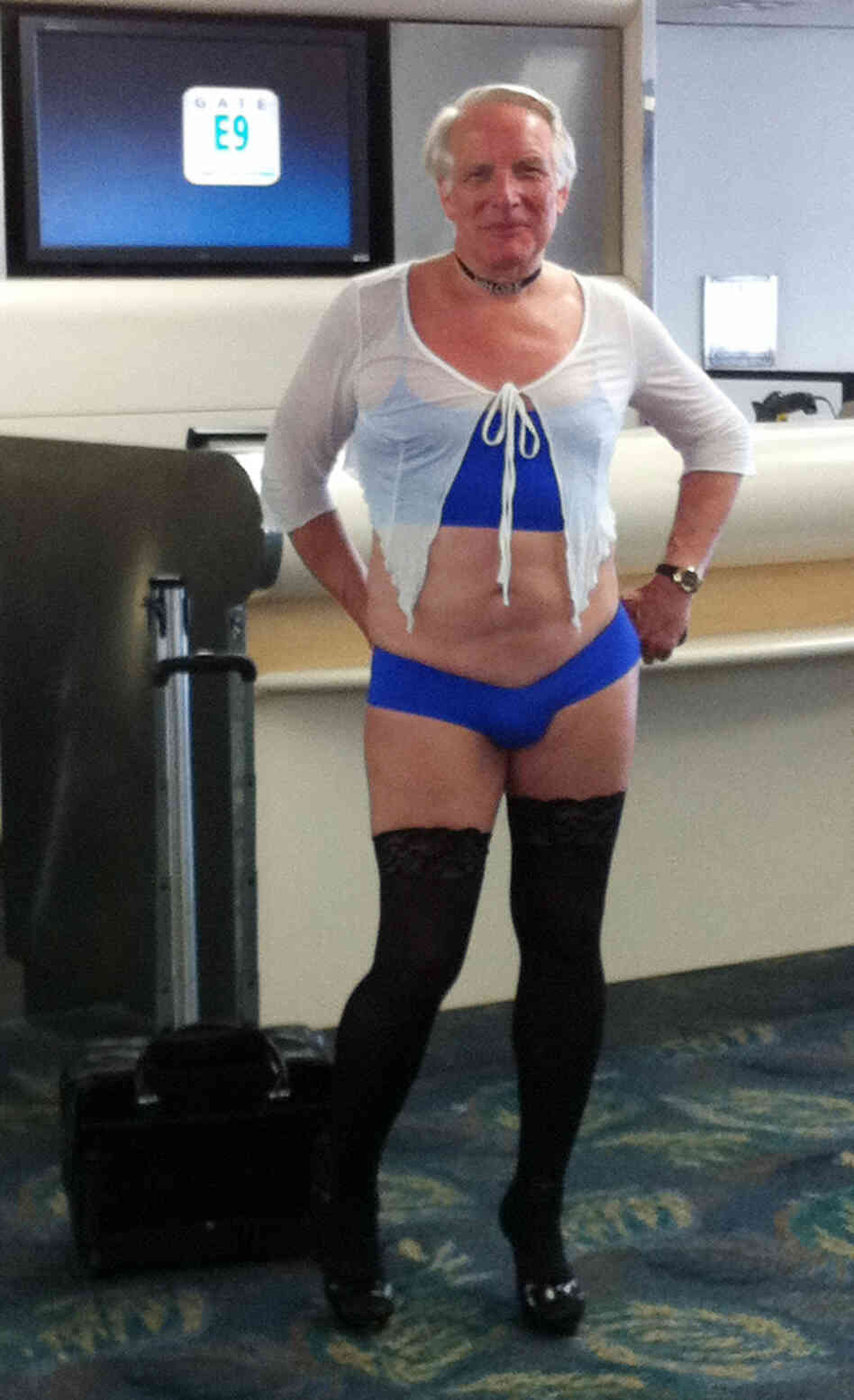 This is a June 9, 2011, photo provided by airline passenger Jill Tarlow showing an unnamed passenger scantily dressed and taken at the airport in Fort Lauderdale, Fla.