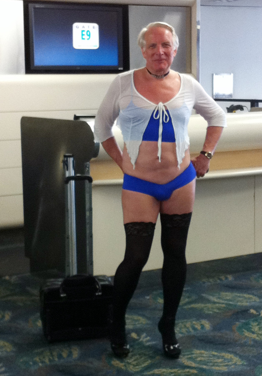 This is a June 9, 2011, photo provided by airline passenger Jill Tarlow showing an unnamed passenger scantily dressed and taken at the airport in Fort Lauderdale, Fla.