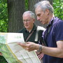 Edward Barnard (left) and Ken Chaya look at their map of Central Park as they stand in its North Woods.