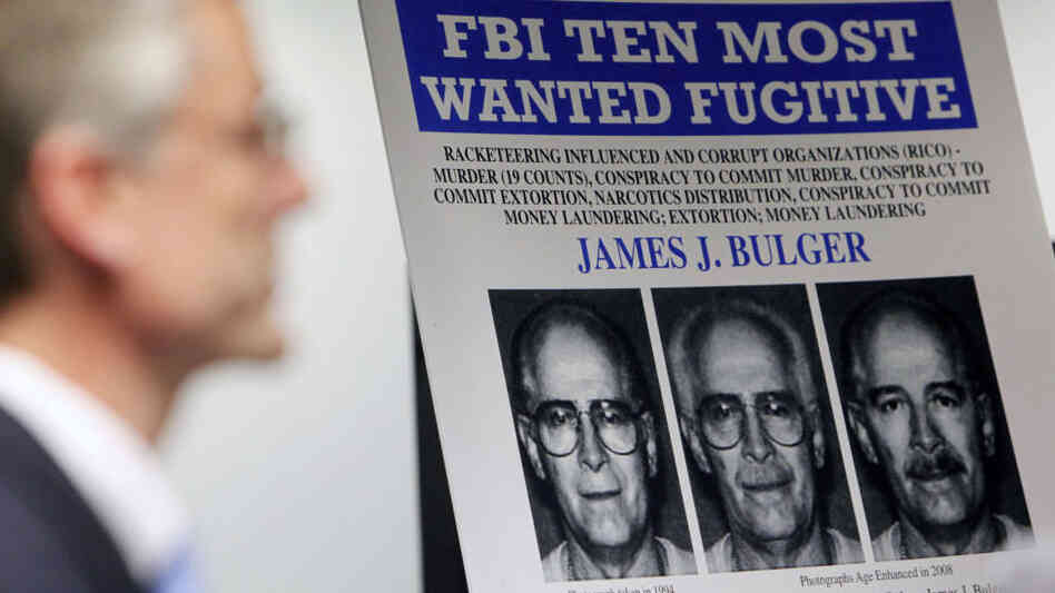 FBI special agent Richard Deslauriers speaks Monday during a news conference next to a poster featuring fugitive James "Whitey" Bulger at the FBI field office in Boston.