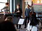 The Mason Jar team conducts a recording session with a chamber orchestra and The Wood Brothers (sitting on the desk, Chris on the left and Olive on the right) in a classroom at St. Cecilia's Church in Brooklyn. The Mason Jar team conducts a recording session with a chamber orchestra and The Wood Brothers (sitting on the desk, Chris on the left and Olive on the right) in a classroom at St. Cecilia's Church in Brooklyn.