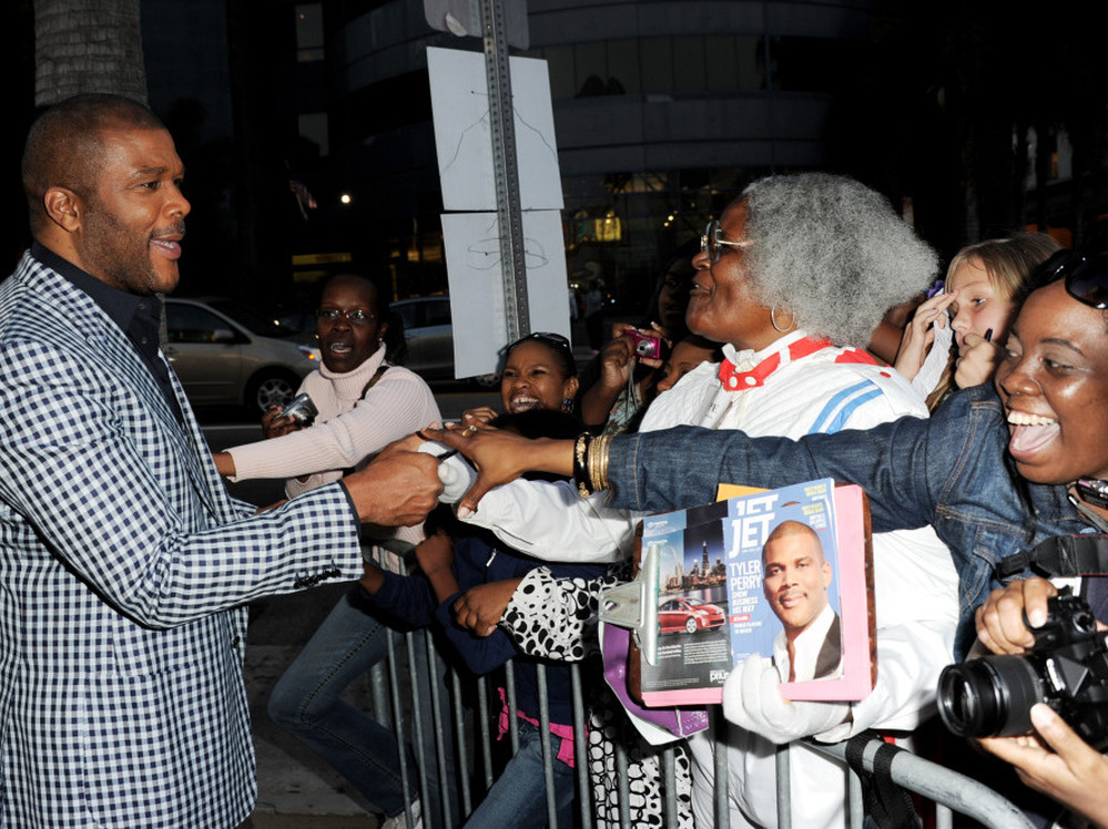 Writer/producer/director/actor Tyler Perry (left) greets fans at a screening of Lionsgate Films' Tyler Perry's Madea's Big Happy Family at the Cinerama Dome Theater on April 19 in Los Angeles.