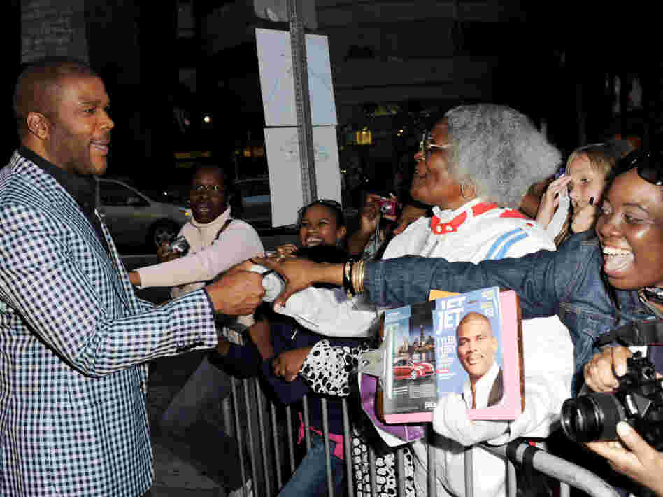Writer/producer/director/actor Tyler Perry (left) greets fans at a screening of Lionsgate Films' Tyler Perry's Madea's Big Happy Family at the Cinerama Dome Theater on April 19 in Los Angeles.