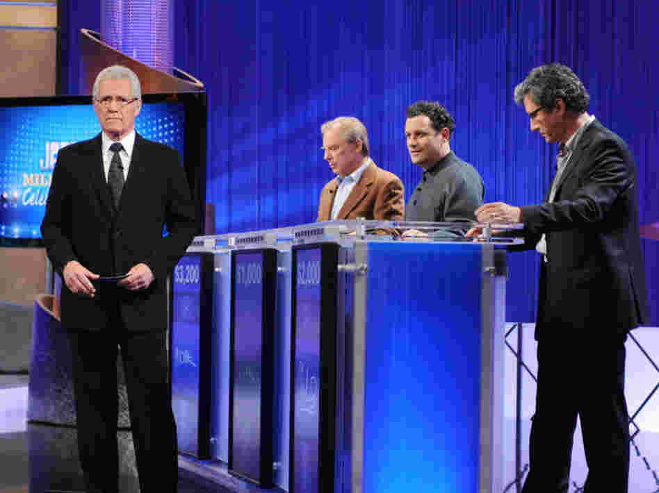 Host Alex Trebek greets celebrity contestants on the set of Jeopardy! For non-celebrity contestants, fame means a 30-second personal anecdote after the first commercial break.