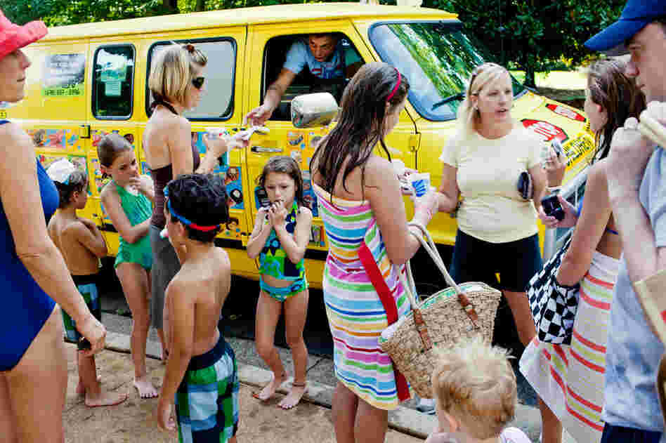 A crowd gathers around iScream, Giedrius Gatautis' ice cream truck company, at one of the pools on his route in Marietta, Ga.