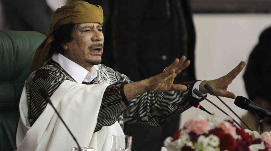 Libyan Leader Moammar Gadhafi gestures to supporters in March as he speaks in Tripoli, Libya. The International Criminal Court issued arrest warrants Monday for Gadhafi, his son and his intelligence chief for crimes against humanity in the early days of their struggle to cling to power. Libyan Leader Moammar Gadhafi gestures to supporters in March as he speaks in Tripoli, Libya. The International Criminal Court issued arrest warrants Monday for Gadhafi, his son and his intelligence chief for crimes against humanity in the early days of their struggle to cling to power.