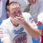 Competitive eaters down their frankfurters during the 2010 Nathan's Famous Fourth of July International Hot Dog Eating Contest at the original Nathan's Famous on Coney Island.