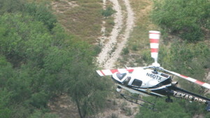 When a group of suspected illegal crossers spots DPS helicopters hovering over the Rio Grande, they run and hop back into this truck which speeds away from the river near Reynosa, Mexico.