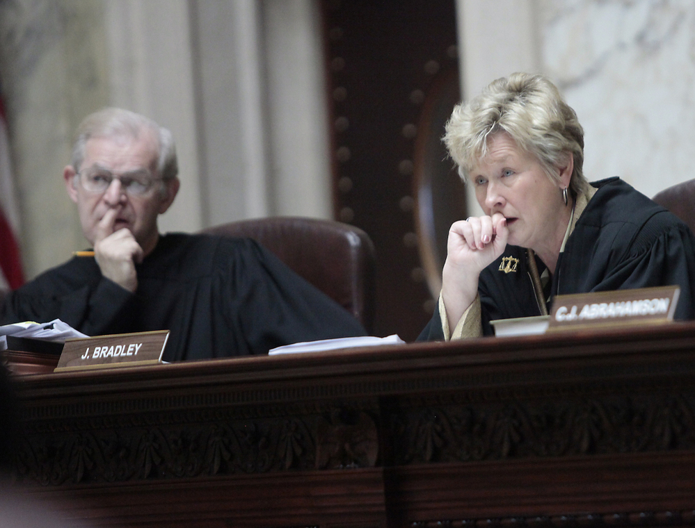 Wisconsin Supreme Court Justices David T. Prosser, Jr. and Ann Walsh Bradley consider oral arguments during a hearing regarding the state's budget bill at the Wisconsin State Capitol, June 6, 2011.