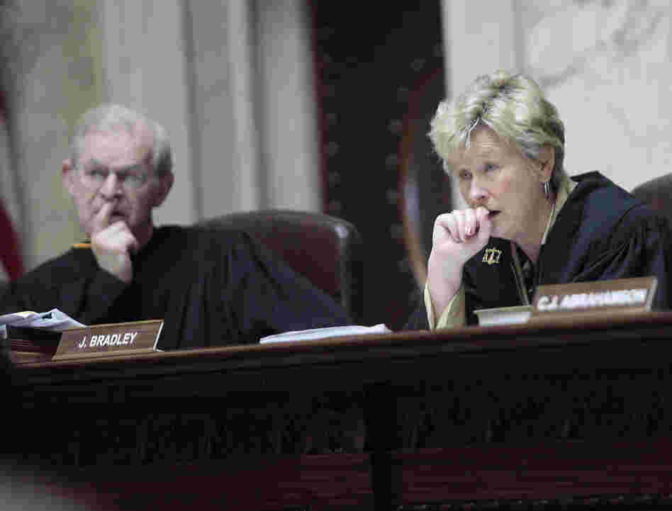 Wisconsin Supreme Court Justices David T. Prosser, Jr. and Ann Walsh Bradley consider oral arguments during a hearing regarding the state's budget bill at the Wisconsin State Capitol, June 6, 2011.
