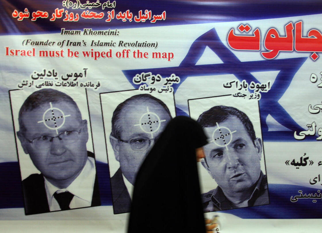 An Iranian woman walks past a poster featuring portraits of Israeli military intelligence chief Gen. Amos Yedlin, Dagan and Defense Minister Ehud Barak during an anti-Israel ceremony in Tehran in 2008.
