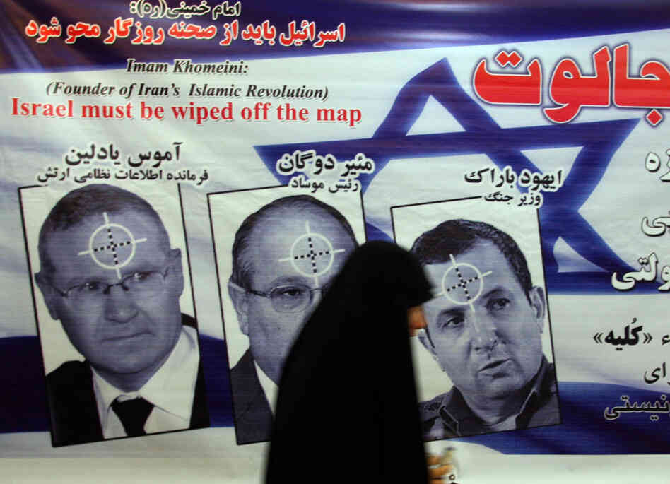 An Iranian woman walks past a poster featuring portraits of Israeli military intelligence chief Gen. Amos Yedlin, Dagan and Defense Minister Ehud Barak during an anti-Israel ceremony in Tehran in 2008.