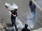Earlier today (June 28, 2011) in Athens, a demonstrator threw a tear gas grenade back toward police. Earlier today (June 28, 2011) in Athens, a demonstrator threw a tear gas grenade back toward police.