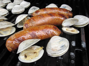 Chorizo and clams cooking on a grill