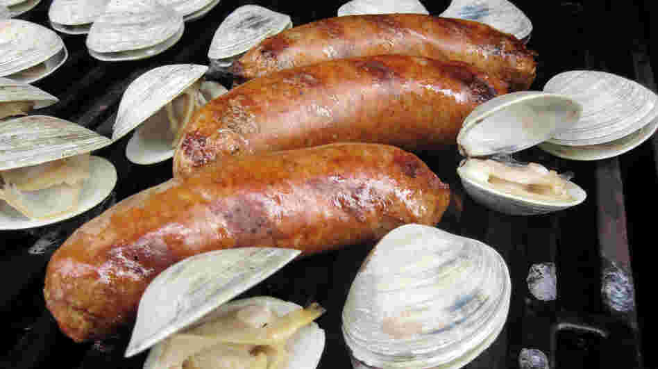 Chorizo and clams cooking on a grill