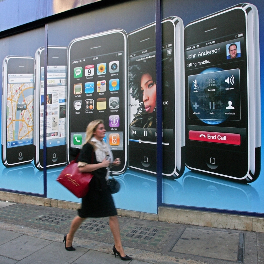 A woman walks by a new Apple location in London. Chen says the iPhone's reach has extended beyond the gadget market to impact all areas of our lives.