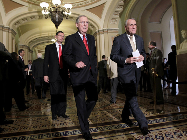 Senate Minority Leader Mitch McConnell (l) with Minority Whip Jon Kyl and Sen. John Barrasso   arrives to speak with reporters, June 28, 2011.