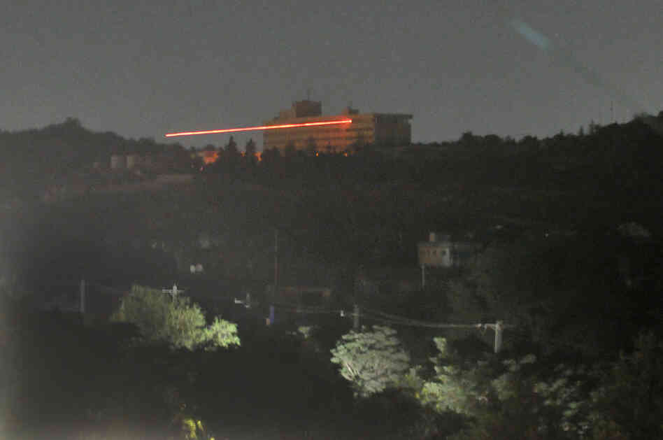 The Inter-Continental hotel in seen in the dark as tracer bullets are shot during an attack in Kabul. The Inter-Continental hotel in seen in the dark as tracer bullets are shot during an attack in Kabul.