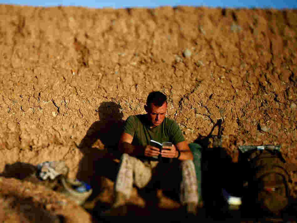 Darryl St. George, a Navy corpsman with Weapons Company of the 2nd Battalion, 8th Marines out of Camp Lejeune, N.C., reads a book as the sun rises over a temporary base nicknamed "Patrol Base Suc" in Helmand province, southern Afghanistan. Darryl St. George, a Navy corpsman with Weapons Company of the 2nd Battalion, 8th Marines out of Camp Lejeune, N.C., reads a book as the sun rises over a temporary base nicknamed "Patrol Base Suc" in Helmand province, southern Afghanistan.