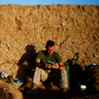 Darryl St. George, a Navy corpsman with Weapons Company of the 2nd Battalion, 8th Marines out of Camp Lejeune, N.C., reads a book as the sun rises over a temporary base nicknamed "Patrol Base Suc" in Helmand province, southern Afghanistan. Darryl St. George, a Navy corpsman with Weapons Company of the 2nd Battalion, 8th Marines out of Camp Lejeune, N.C., reads a book as the sun rises over a temporary base nicknamed "Patrol Base Suc" in Helmand province, southern Afghanistan.