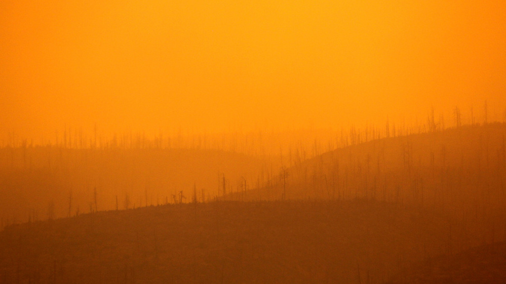 The sun filters through thick smoke from a wildfire burning near Los Alamos, N.M..