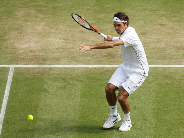 Roger Federer of Switzerland returns a shot during his quarterfinal round match against Jo-Wilfried Tsonga of France on Day Nine of the Wimbledon Lawn Tennis Championships at the All England Lawn Tennis and Croquet Club.