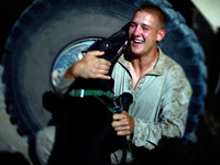 Marine Pfc. Dave Kroha, 23, from Cromwell, Conn., plays with his bomb-sniffing dog, Mike. Kroha dropped out of college and was in a few bar fights before his mother jokingly suggested that he go and fight for his country. The next day he enlisted in the Marine Corps.