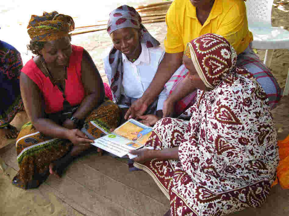 A group of traditional birth attendants took part in a yearlong trial of misoprostol in rural areas of Mozambique. Here they review a booklet on proper administration of the pills.
