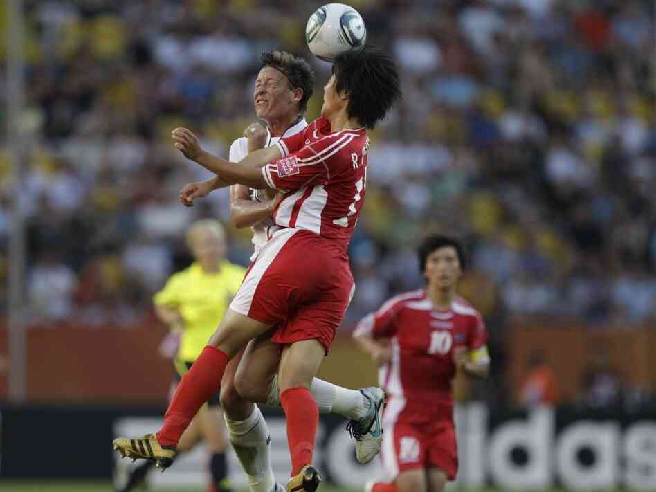 Abby Wambach of the United States battles against North Korea's Ri Un Hyang during the group C match between the United States and North Korea at the Womenâs Soccer World Cup in Dresden, Germany, Tuesday, June 28, 2011.