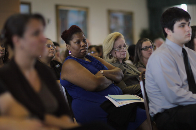 Residents listen during a public hearing on Florida's new Medicaid overhaul, in Miami Gardens, Fla., on June 16.  The overhaul, championed by Gov. Rick Scott as an attempt to save the state money, still needs federal approval.