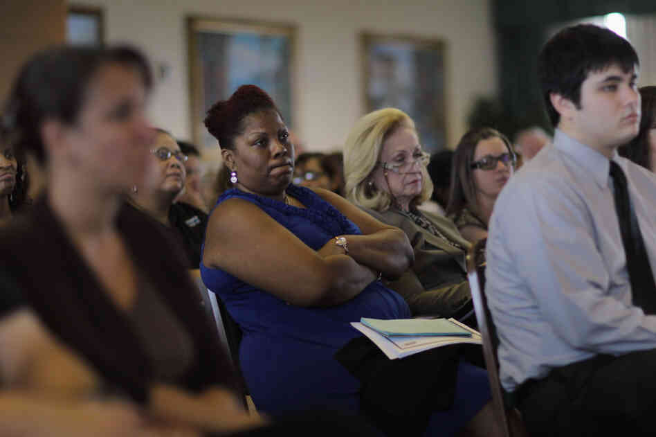 Residents listen during a public hearing on Florida's new Medicaid overhaul, in Miami Gardens, Fla., on June 16.  The overhaul, championed by Gov. Rick Scott as an attempt to save the state money, still needs federal approval.