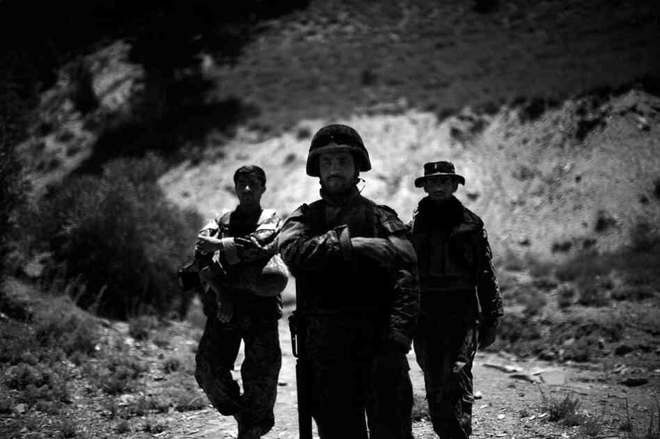 Afghan National Army troops take a break while on a joint patrol and clearing operation with Butcher Troop.