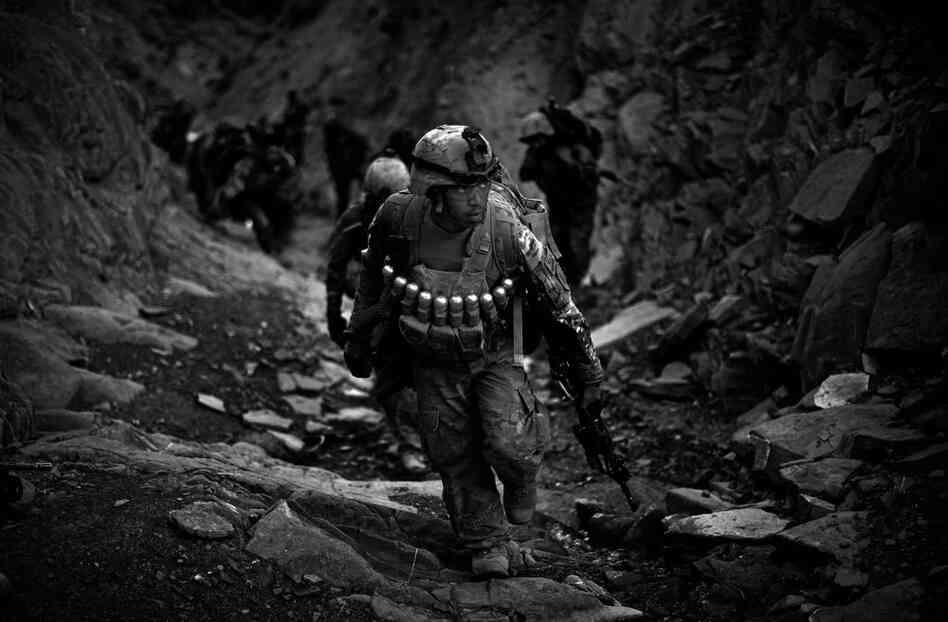 Soldiers with Butcher Troop, part of the U.S. Army's 1st Infantry Division, and Afghan National Army troops climb the treacherous mountains overlooking the Khost-Gardez highway while on a mission to disrupt insurgent fighters in the area. 