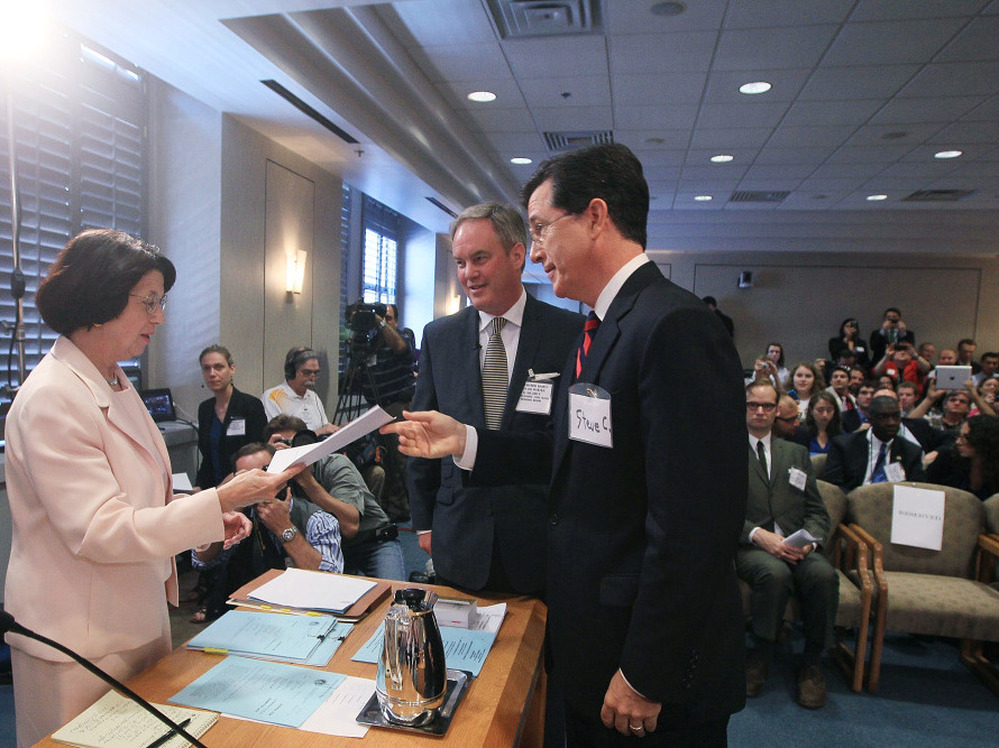 Comedian Stephen Colbert with his attorney, Trevor Potter, turns in a document at a Federal Election Commission hearing, June 30, 2011.