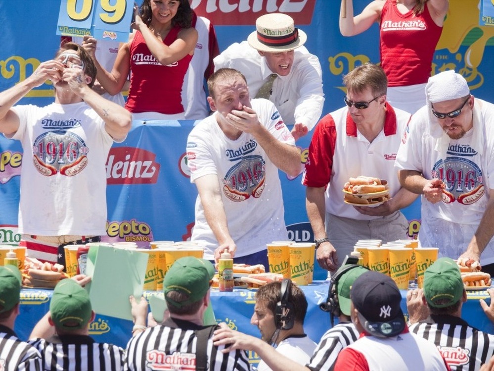 Competitive eaters down their frankfurters in the 2010 Nathan's Famous Fourth of July International Hot Dog Eating Contest at the original Nathan's Famous in Coney Island.