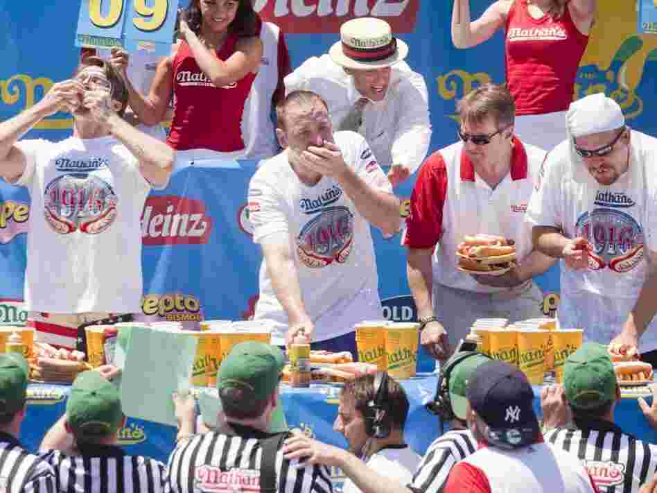 Competitive eaters down their frankfurters in the 2010 Nathan's Famous Fourth of July International Hot Dog Eating Contest at the original Nathan's Famous in Coney Island.